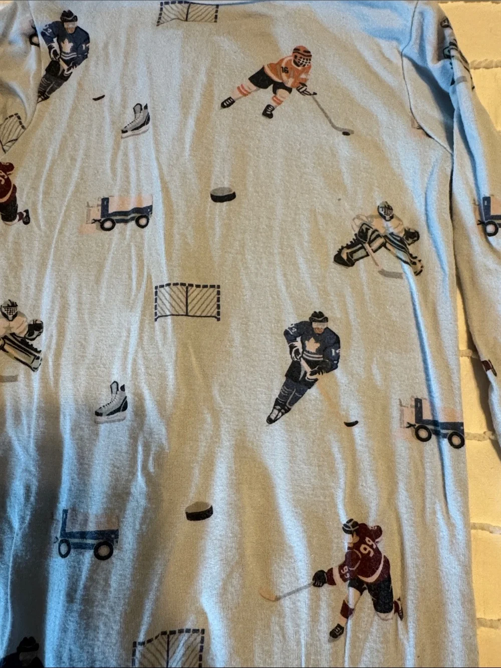 Kyte BABY 6-12 mo Light Blue Hockey & Skate Print Footed One-Piece